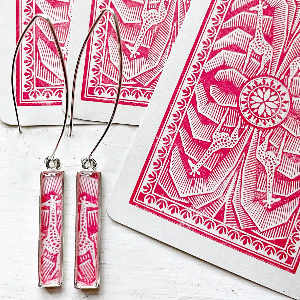 silver drop earrings with giraffes made from playing cards red and white
