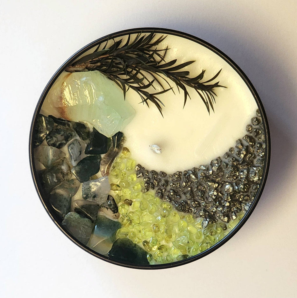The 8oz Soy Crystal Intention Candle features green calcite, moss agate, peridot, and pyrite with a cedarwood + cypress scent; it's hand-poured with 100% American soy wax and phthlate-free essential oils and fragrance