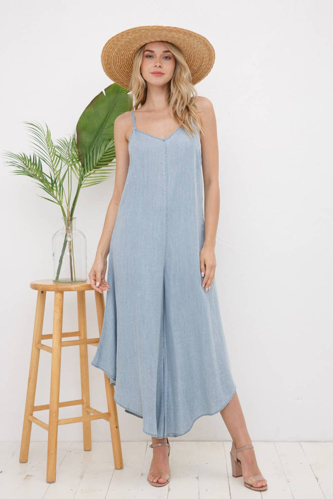 Wear this tencel jumpsuit just about anywhere. Featuring a wide-leg, asymmetrical style and minimalist cutout in the back, this boho outfit can be dressed up or down. It will be a new staple front and center in your closet.