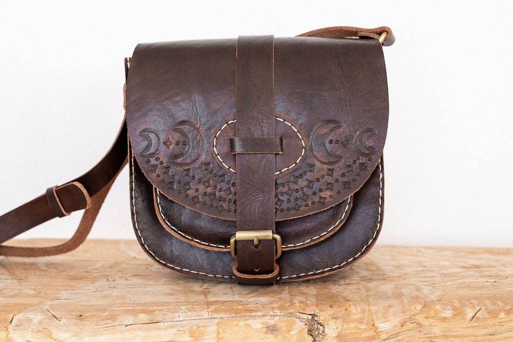 la lune crossbody bag in vintage brown featuring moon design pressed in sustainably sourced leather with brass closure