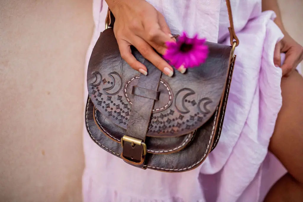 la lune crossbody bag in vintage brown featuring moon design pressed in sustainably sourced leather with brass closure