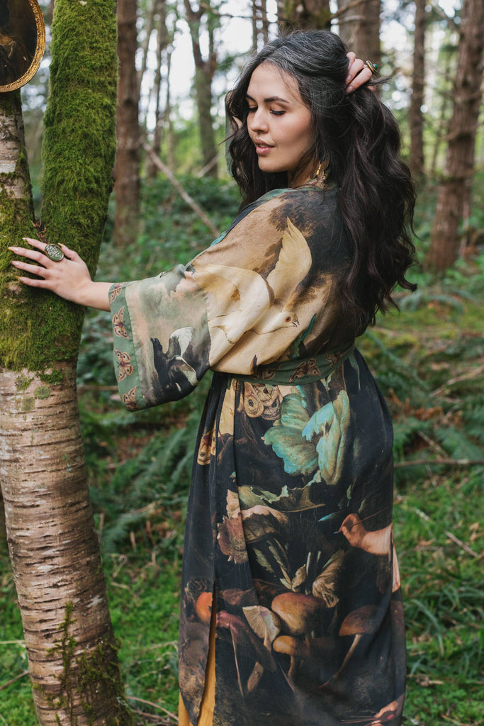 gypsy wrap, artistic kimono, Introducing Heartwork—a tribute to the indomitable, heart-centred spirit of women in art!, this stunning piece features a painting by artist Artemisia Gentileschi's self-portrait, surrounded by lushly painted forest landscapes, birds, and butterflies