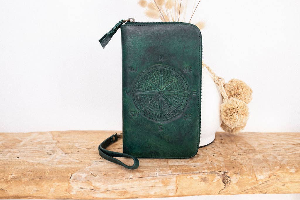 the Wander Travel Wallet will get you ready for your next adventure, whether by road, sky, or sea, featuring a hand-embossed compass on the front of the wallet