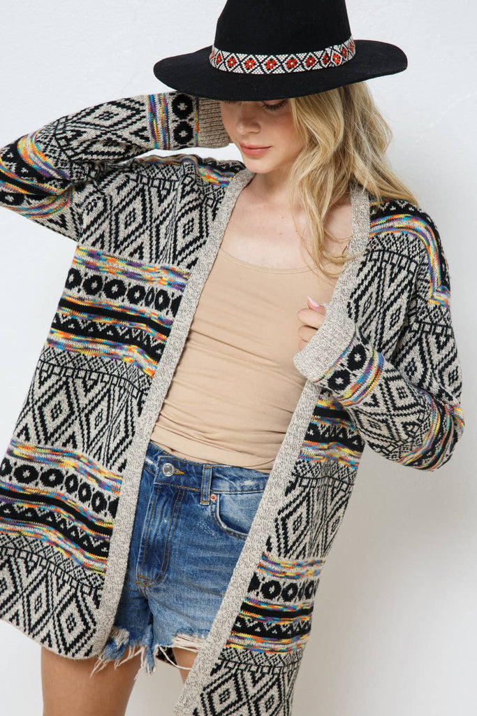 Add a bohemian flair to your outfit on chilly days with this Aztec multicolor cardigan. Black and cream are the primary colors with hints of coral and teal. 