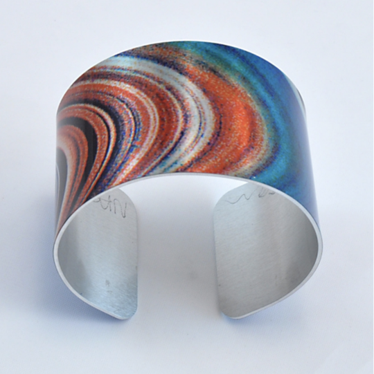 This cuff bracelet is designed using an original photograph and printed on lightweight aluminum. It's scratch resistant, durable, and comfortable on the wrist. Measures 6.63 x 1.63 inches and adjustable so one size fits all.