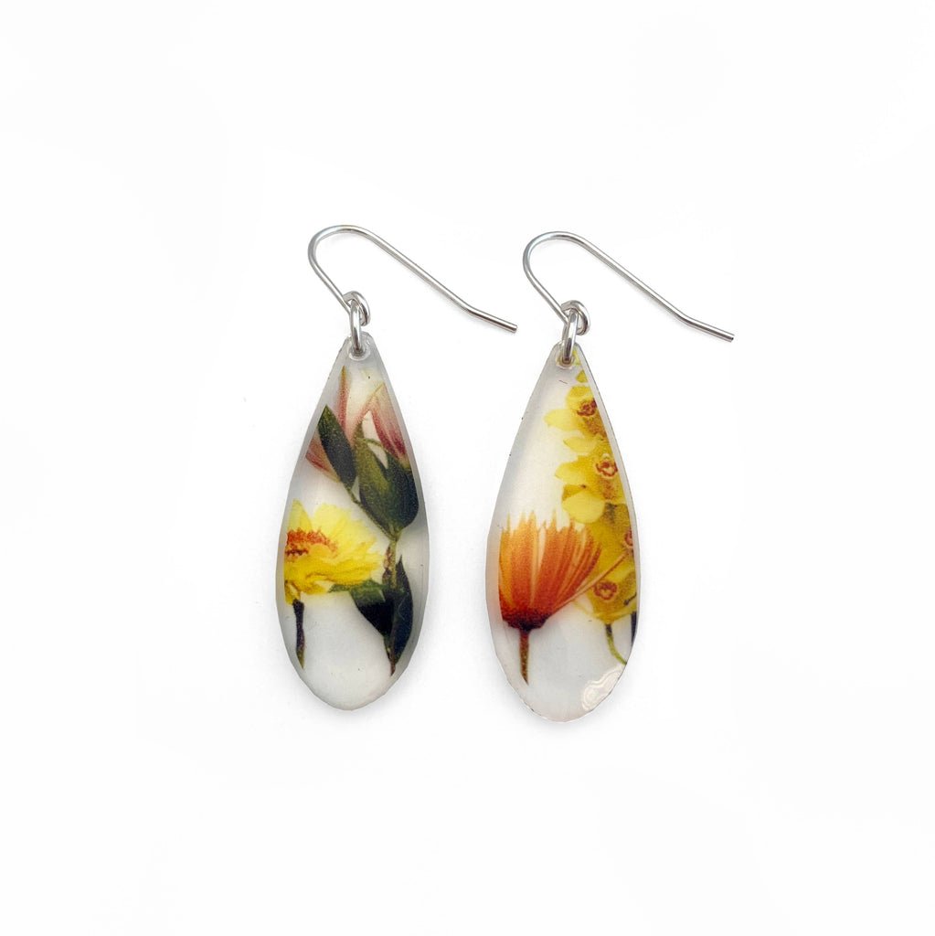drip bouquet earrings featuring botanicals set in clear acrylic and hanging from sterling silver
